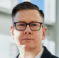 Portrait of Alexander Hughes, executive and chief executive officer of a crypto trading company